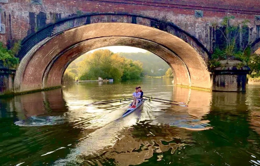 A Pangbourne School double scull rowing through Gatehampton bridge.